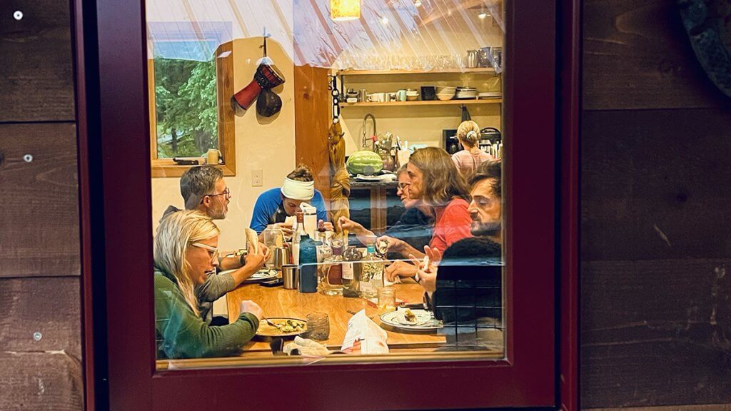 Guests sharing dinner together at Hayden Backcountry Lodge after a day exploring the San Juan Mountains.